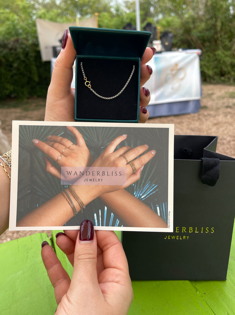 chain necklace in jewelry box with postcard that reads Wanderbliss Jewelry