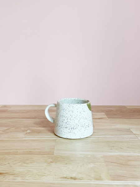 green and cream speckled mug