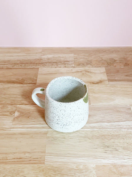 green and cream speckled mug