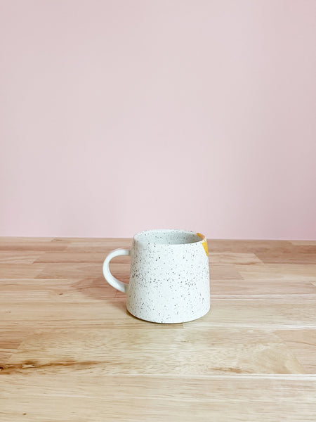 yellow and cream speckled mug