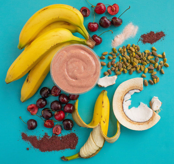 smoothie with fruit and nuts on blue counter