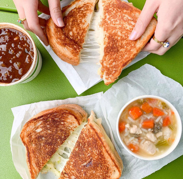 grilled cheese sandwiches and two bowls of soup
