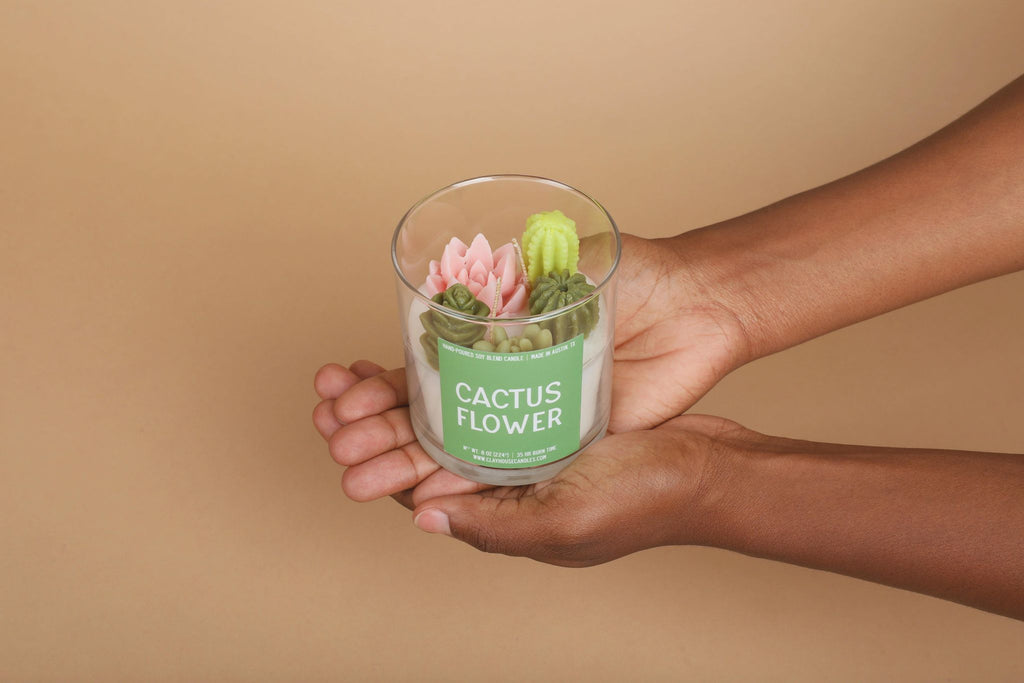 sculptural candle with cacti on top with label that reads cactus flower